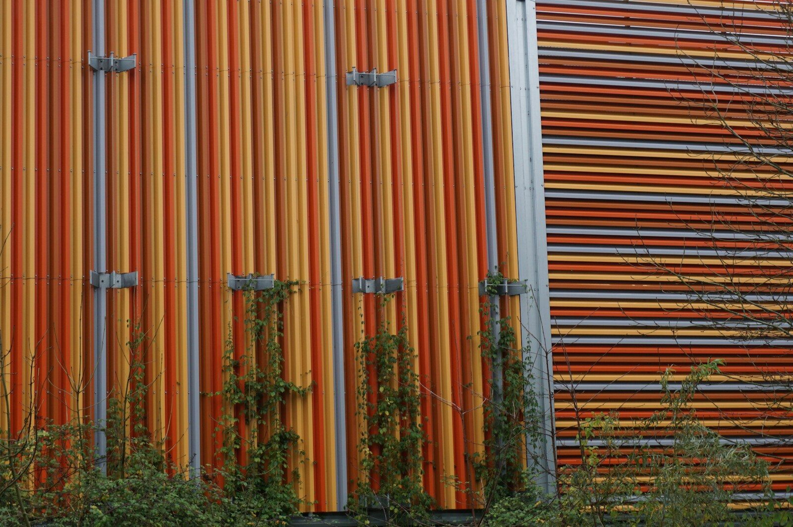 Modern building facade with vertical orange and grey tubes